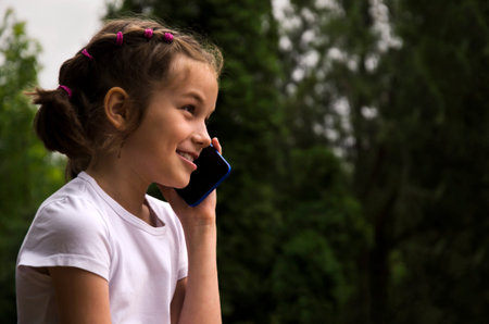 Happy child talking on mobile phone.の写真素材