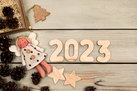 Happy New Year 2023. Symbol from number 2023 on wooden background