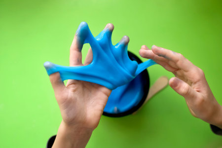 Children's hands play with a slime toy. Selective focus