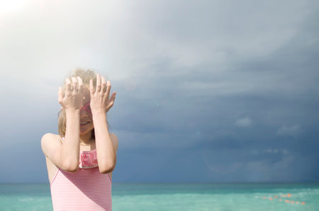 Girl on the beach wearing goggles for swimmingの写真素材