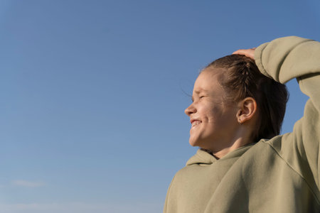 Portrait of a girl against the blue sky