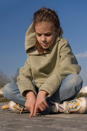 Girl sitting on the track after rollerbladingの写真素材