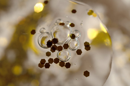 air bubbles and glitter in cosmetic serum on a festive background for advertising and presentation...