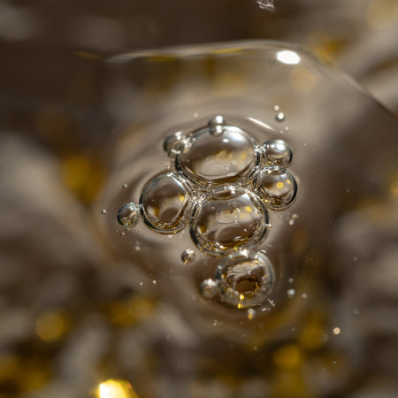 Surface of oil or serum with bubbles. Abstract festive cosmetic backgroundの写真素材
