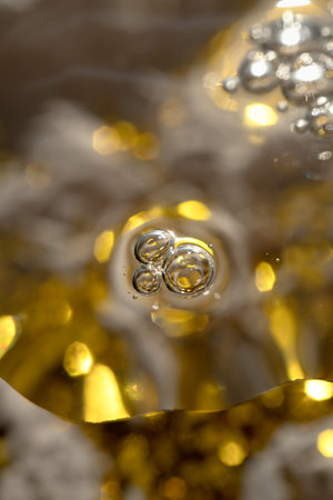 air bubbles and glitter in cosmetic serum on a festive background for advertising and presentation.の写真素材