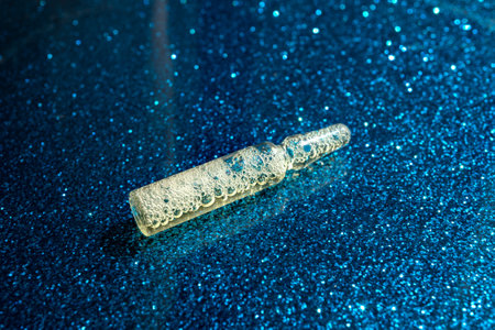 Glass ampoules with yellow medicine are on the tableの写真素材