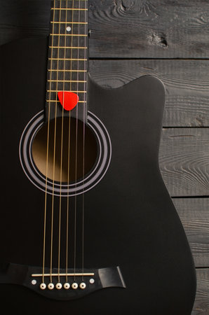 Mediator and black six-string guitar. Musical background for your businessの写真素材