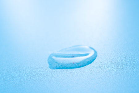 Drop of cosmetic product on a blue backgroundの写真素材