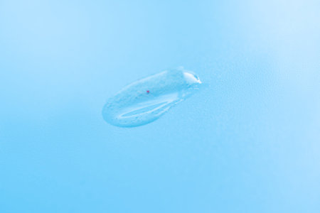 Drop of cosmetic product on a blue background. Skin deep cleanser, exfoliation
