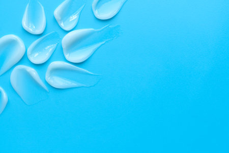 face cream on a blue background. Smear of cosmetic product on a light background with copy spaceの写真素材