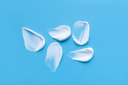 face cream on a blue background. Smear of cosmetic product on a light backgroundの写真素材