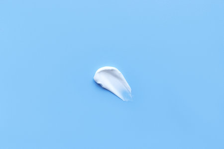 face cream on a blue background. Smear of cosmetic product on a light backgroundの写真素材