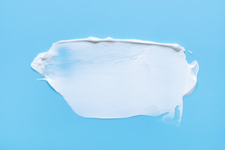 face cream on a blue background. Smear of cosmetic product on a light backgroundの写真素材