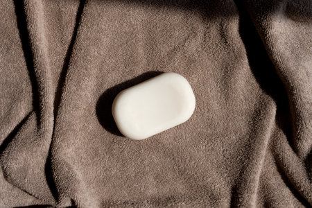 Soap for face and body on a brown towel. Body care. SPA treatmentsの写真素材