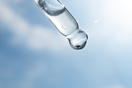 Pipette with essential oil on bottle blurred backgroundの写真素材