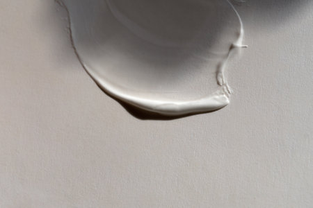 Green cream smeared on light backgroundの写真素材