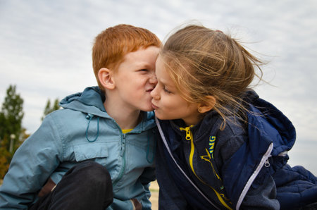Children kiss funny. Brother kisses sisterの写真素材