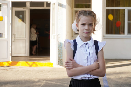 Portrait 11 year old girl schoolgirls with a thoughtful look as if solving a problem.の写真素材