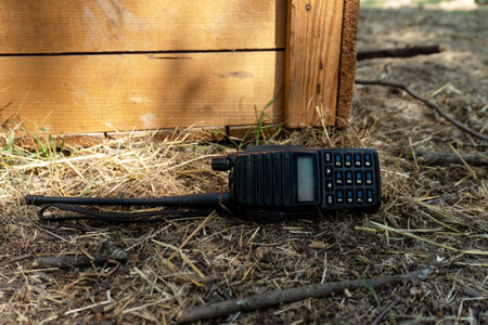 Walkie-talkie lies on the ground against the background of a wooden boxの写真素材