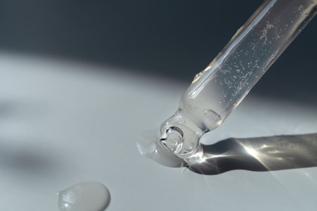 Pipette with essential oil on bottle blurred backgroundの写真素材