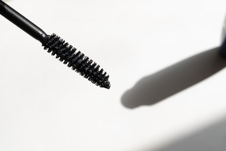 Black mascara in black packaging on a white backgroundの写真素材
