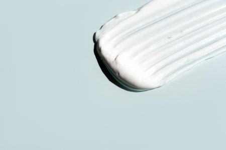 cosmetic smears cream texture on pastel blue backgroundの写真素材