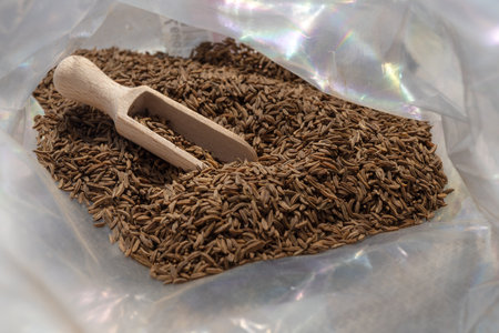dry cumin seeds in a measuring spoonの写真素材