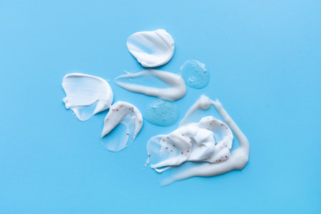 face cream and scrubs on a blue background. Smear of cosmetic product on a light backgroundの写真素材