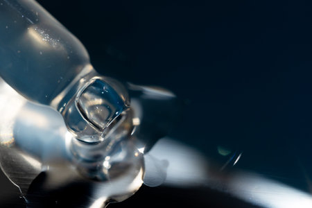 pipette with oil lies on a metal gua sha massager