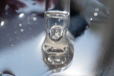 pipette with oil lies on a metal surfaces