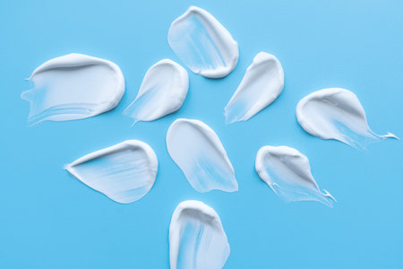 face cream on a blue background. Smear of cosmetic product on a light background