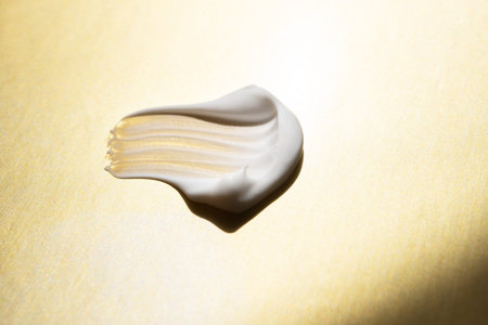 cosmetic smears cream texture on gold background