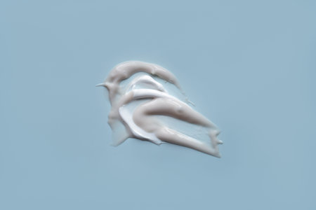 face cream and scrubs on a gray background. Smear of cosmetic product on a light background