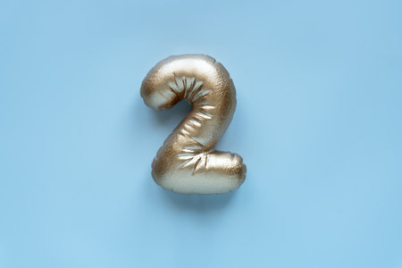 gold volumetric figure 2 on a light background.の写真素材