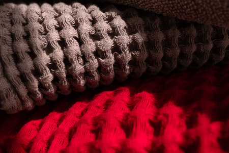 Casually lay colored terry and waffle towels on the shelf. Home textiles close upの写真素材