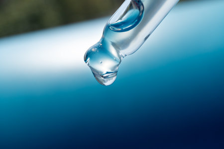 pipette with a drop of cosmetic productの写真素材