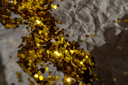 Glitter lies on crumpled wrapping paper. Festive backgroundの写真素材