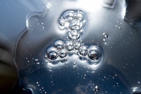 surface of oil or serum with bubbles. festive cosmetic background. Blurred backgroundの写真素材