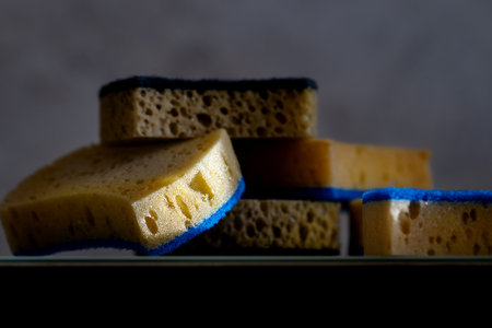 Sponges or sponges for washing dishes, cleaning in the kitchen or bathroom lie on the surface