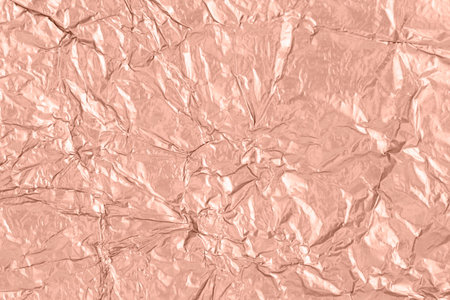 Textured background made of in mocha mousse color sheet foil.