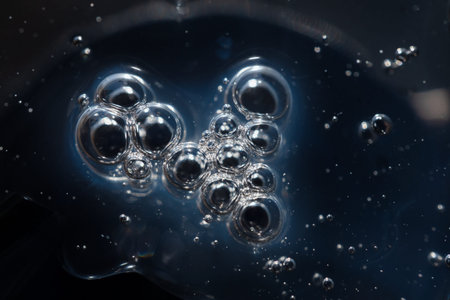 surface of oil or serum with bubbles. festive cosmetic background. Blurred background