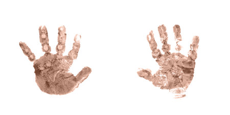 A pair of colorful children's handprints in mocha mousse color on a white background. Family concept.の写真素材