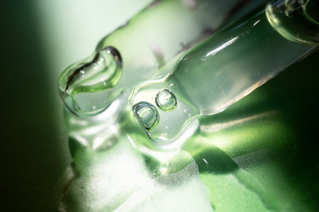 Pipette with essential oil on bottle blurred backgroundの写真素材