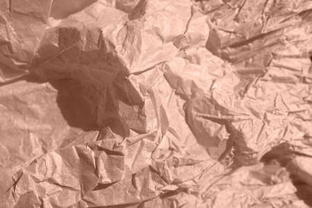 A crumpled piece of kraft paper lies on the surface in mocha mousse colorの写真素材