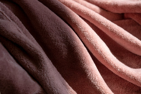 The texture of a soft warm fluffy peach-colored blanket. Textile backgroundの写真素材