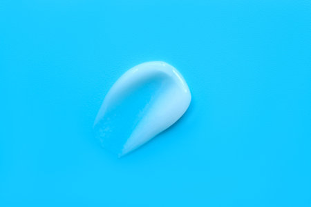 face cream on a blue background. Smear of cosmetic product on a light background