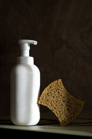 Cleaning agent and sponges for washing dishes, cleaning in the kitchen or bathroom lie on the surfaceの写真素材