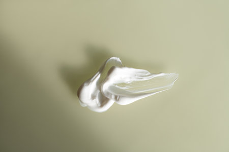 cosmetic smears cream texture on beige backgroundの写真素材