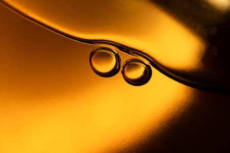 surface of oil or serum with bubbles. festive cosmetic background. Blurred backgroundの写真素材