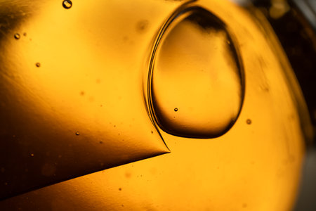 surface of oil or serum with bubbles. festive cosmetic background. Blurred backgroundの写真素材